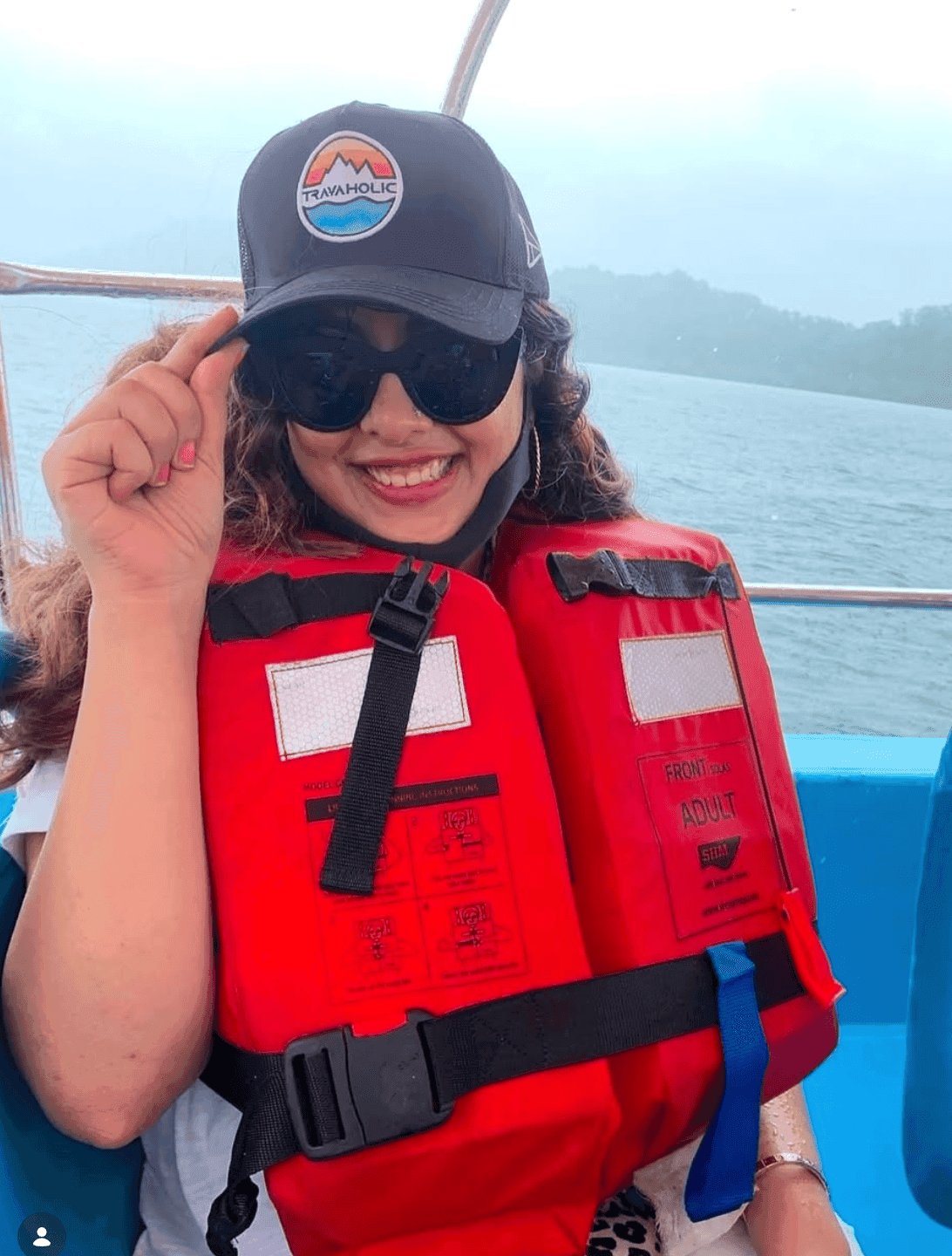 Life jacket on, mist over the water — the kind of boat ride you keep the cap on for the whole way.