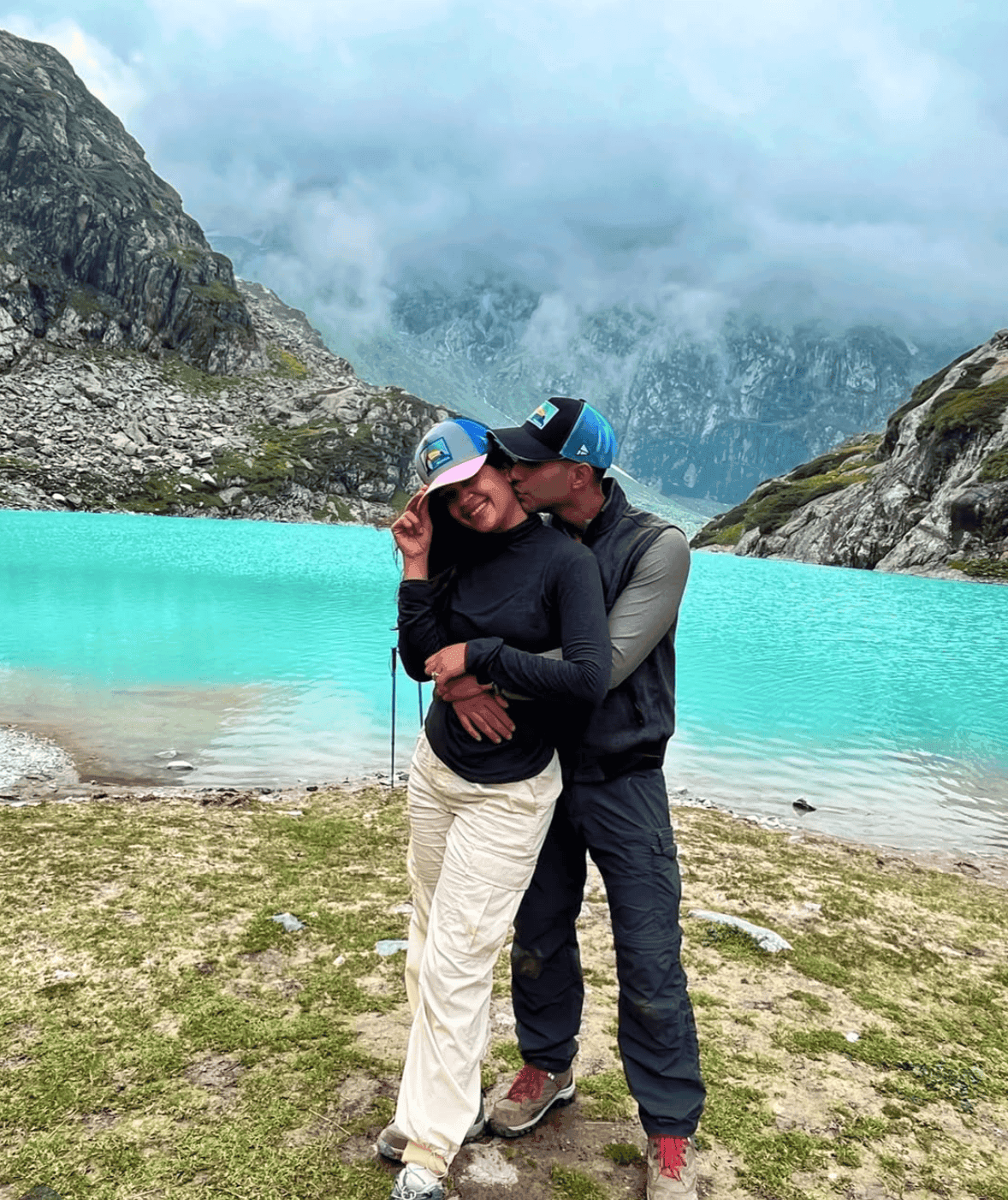 Glacial blue water, a mountain full of cloud, and not much reason to let go of each other.