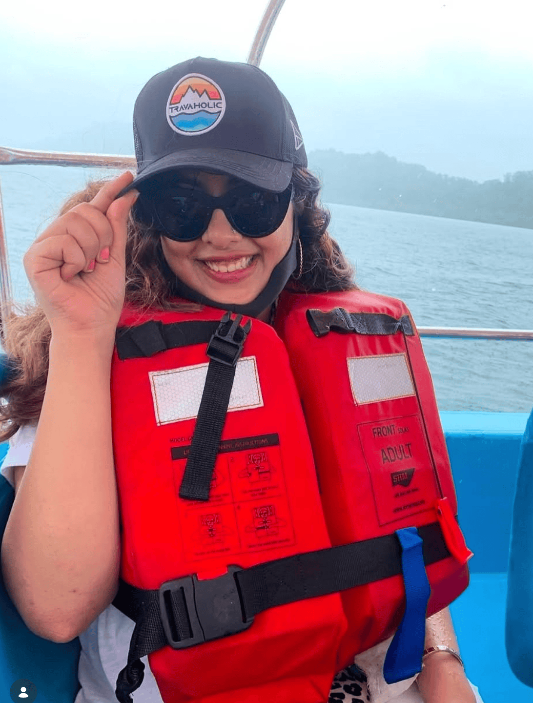 Life jacket on, mist over the water — the kind of boat ride you keep the cap on for the whole way.